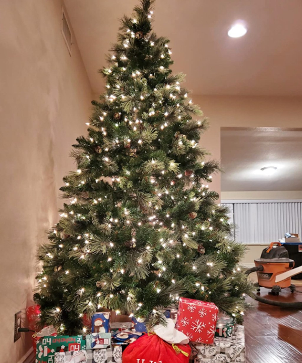 christmas tree with lights and gifts under it
