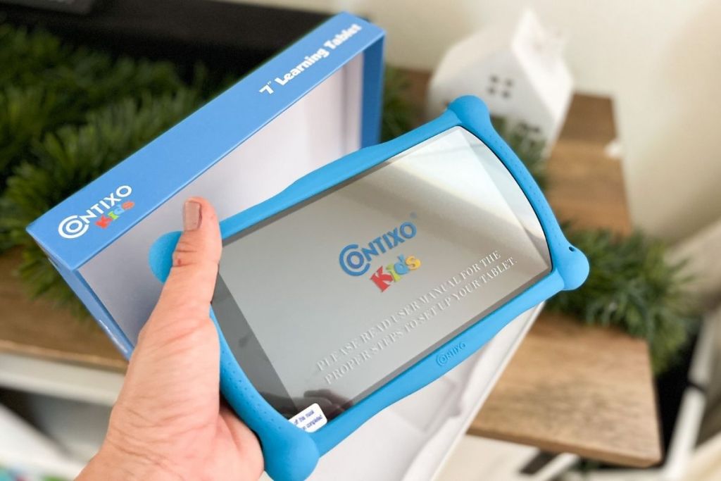 holding Contixo tablet for kids