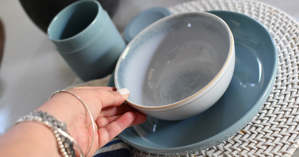 corelle stoneware blue dinnerware set holding bowl