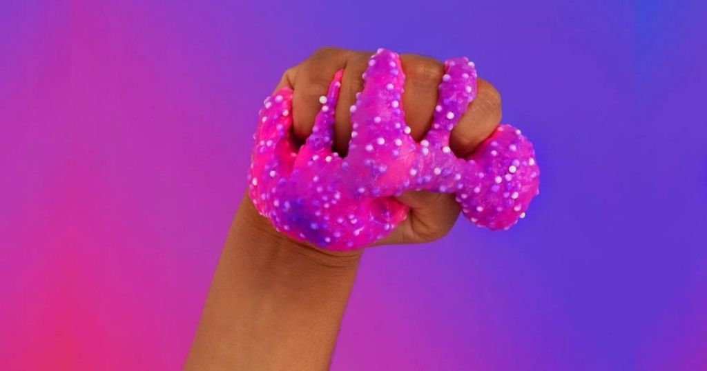 hand holding neon pink and purple slime