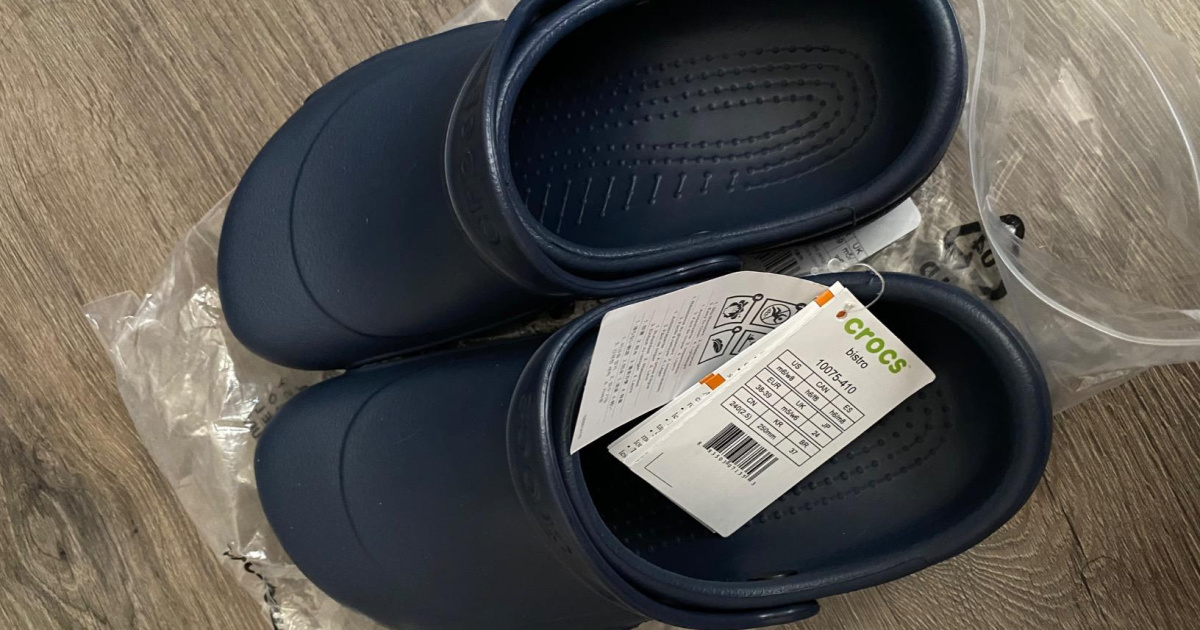 pair of navy crocs clogs with tags