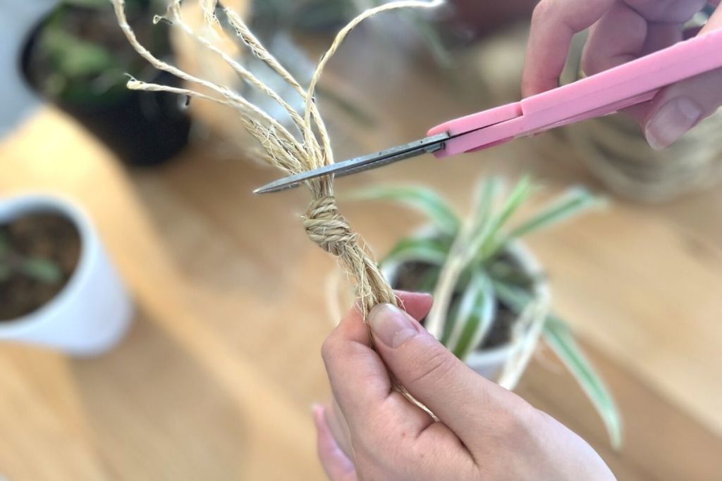 cutting the ends off of a jute rope knot