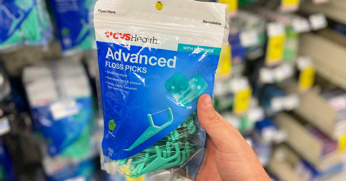 hand holding up a package of floss picks at cvs