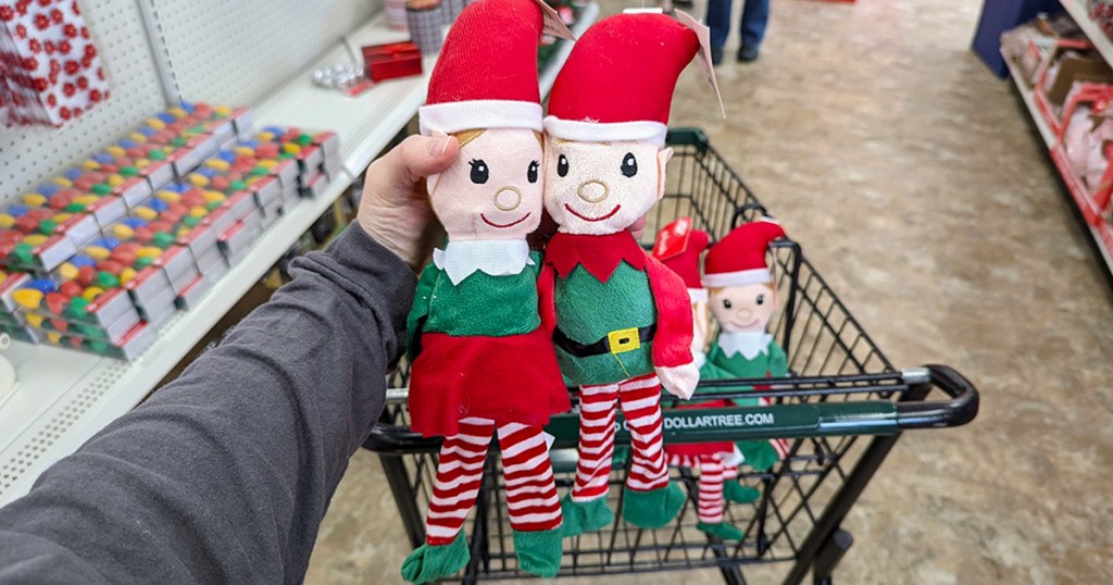 hand holding plush elf dolls at dollar tree