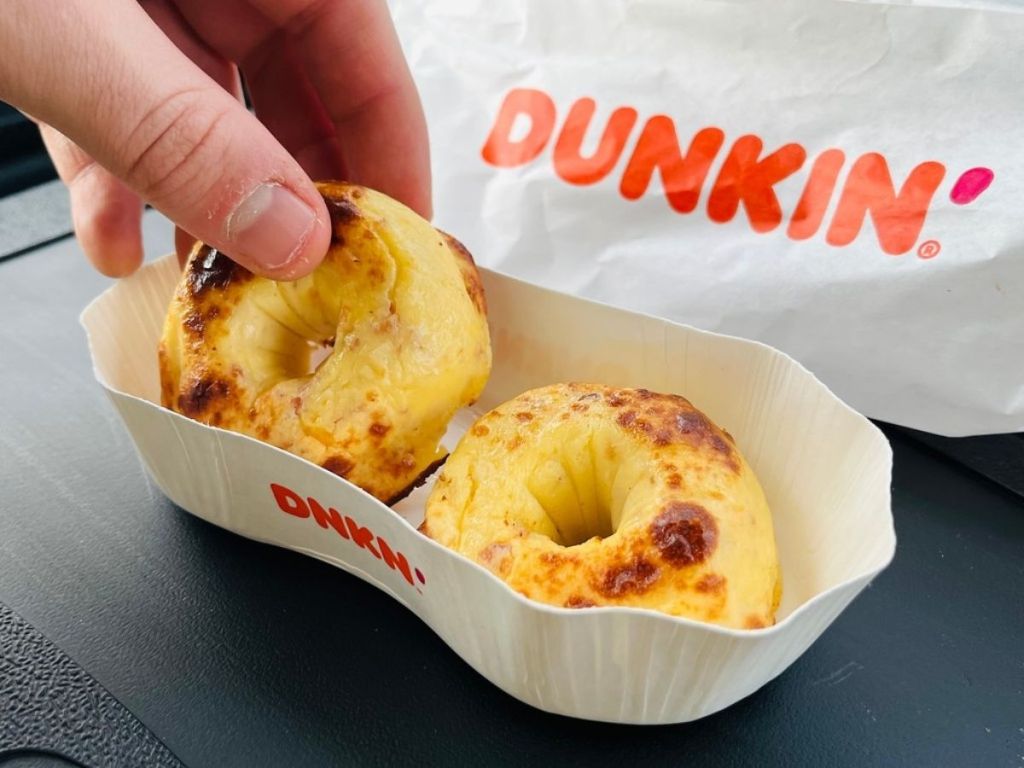 hand pulling out Dunkin Omelet Bites from tray