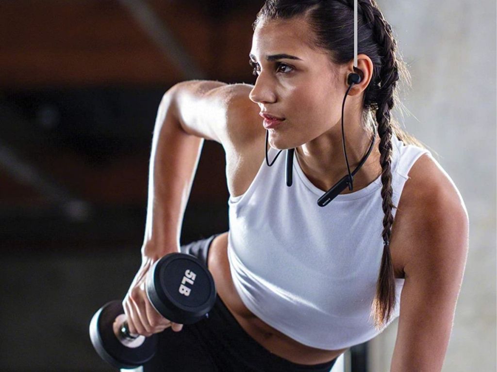 woman working out wearing black earbuds