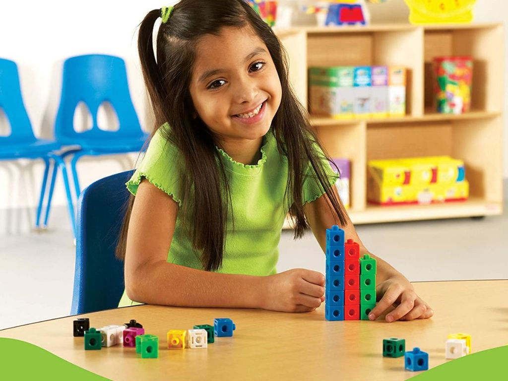 girl playing with snap cubes set