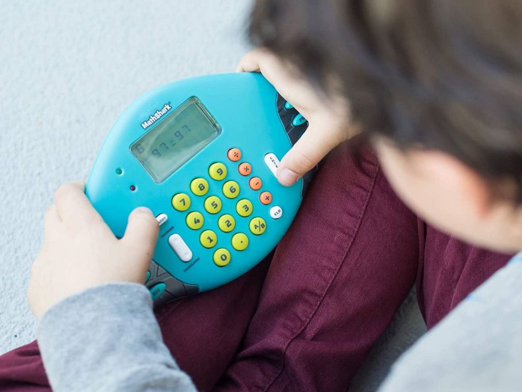 kid playing electronic math game