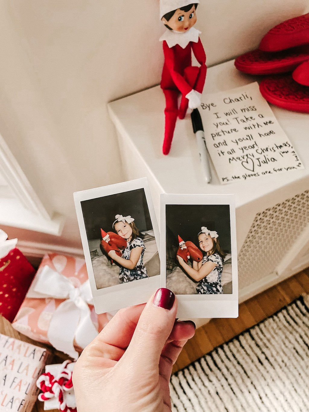 hand holding polaroid pictures with elf on the shelf goodbye note