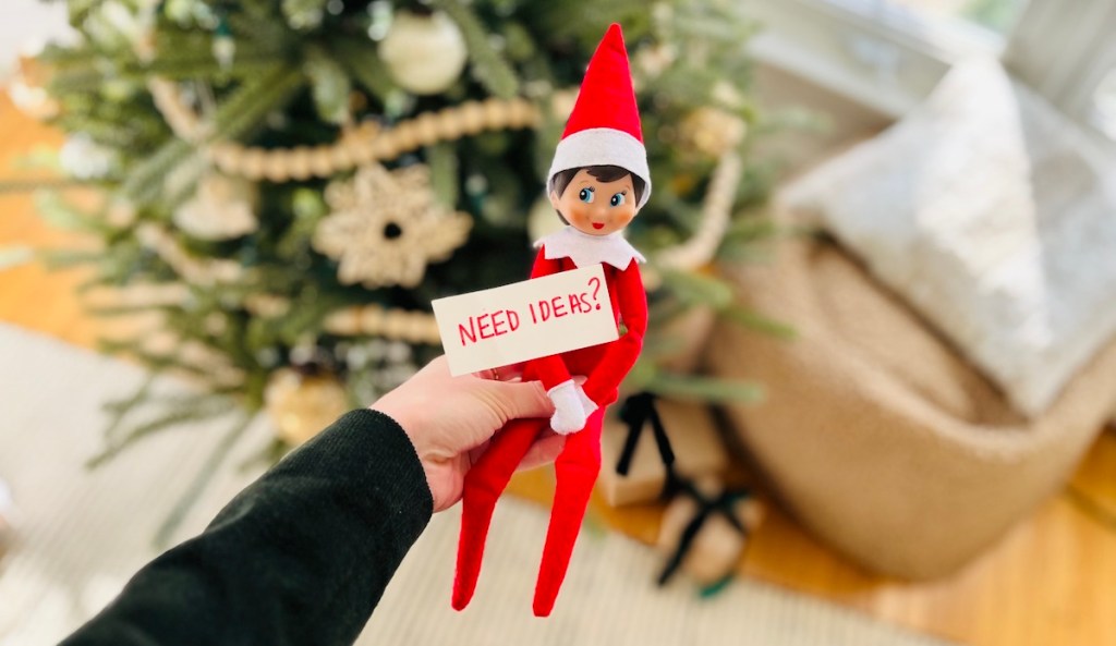 hand holding elf on the shelf with need ideas sign