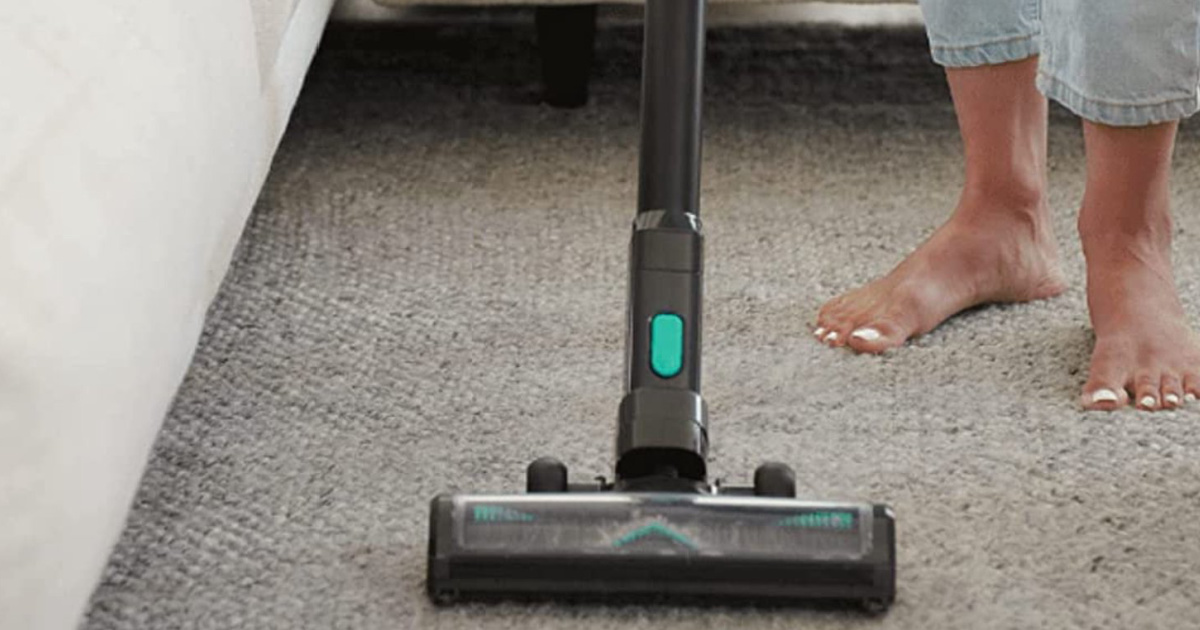 girl vacuuming carpet with cordless vacuum