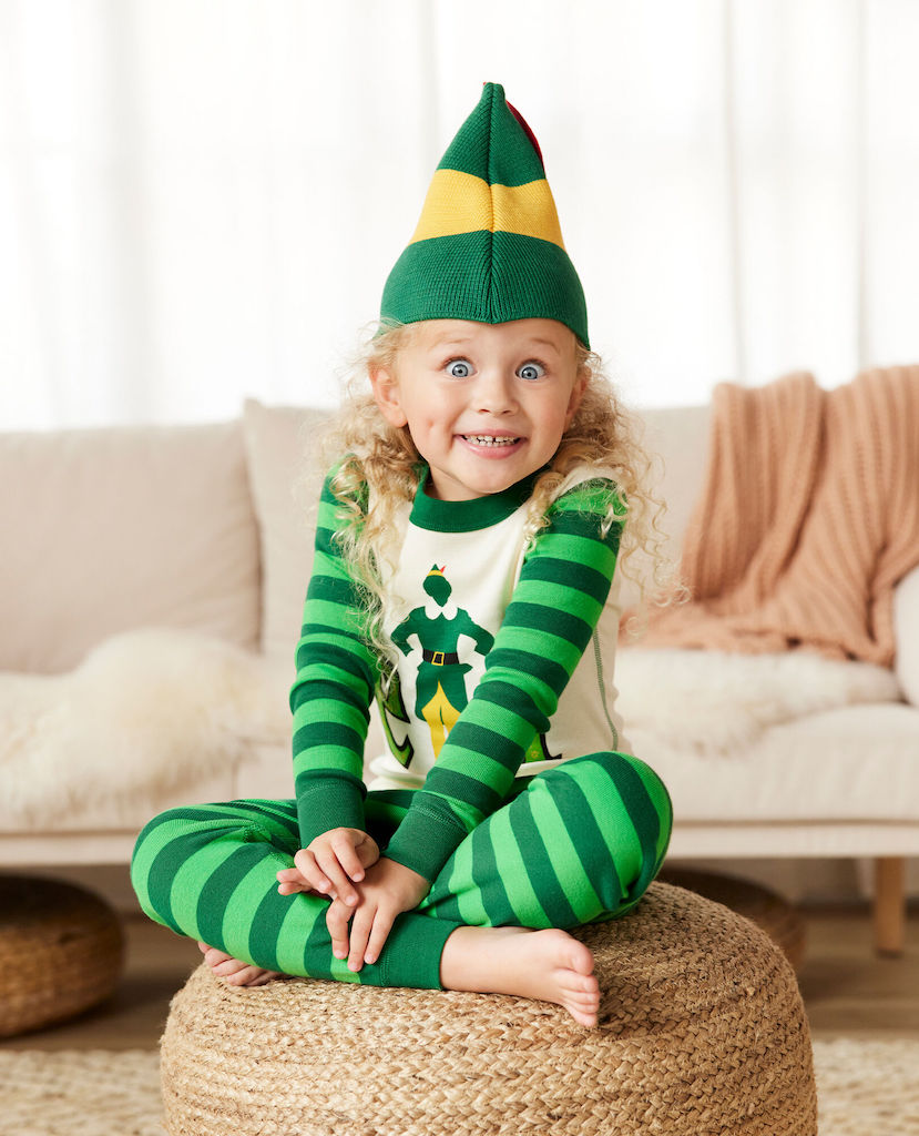 little girl wearing elf matching family pajamas 