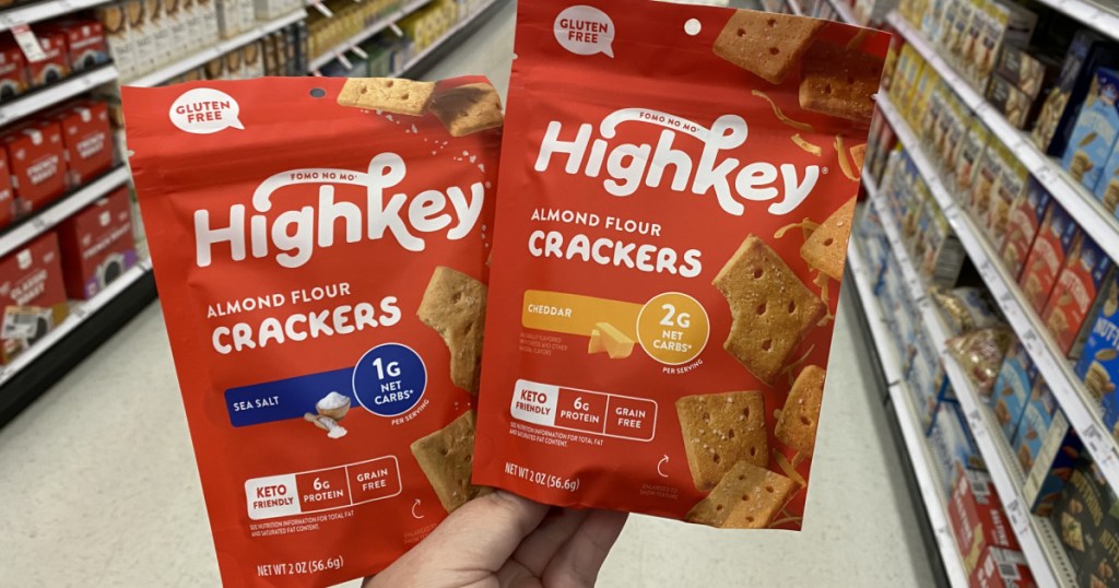 hand holding 2 packages of crackers in store