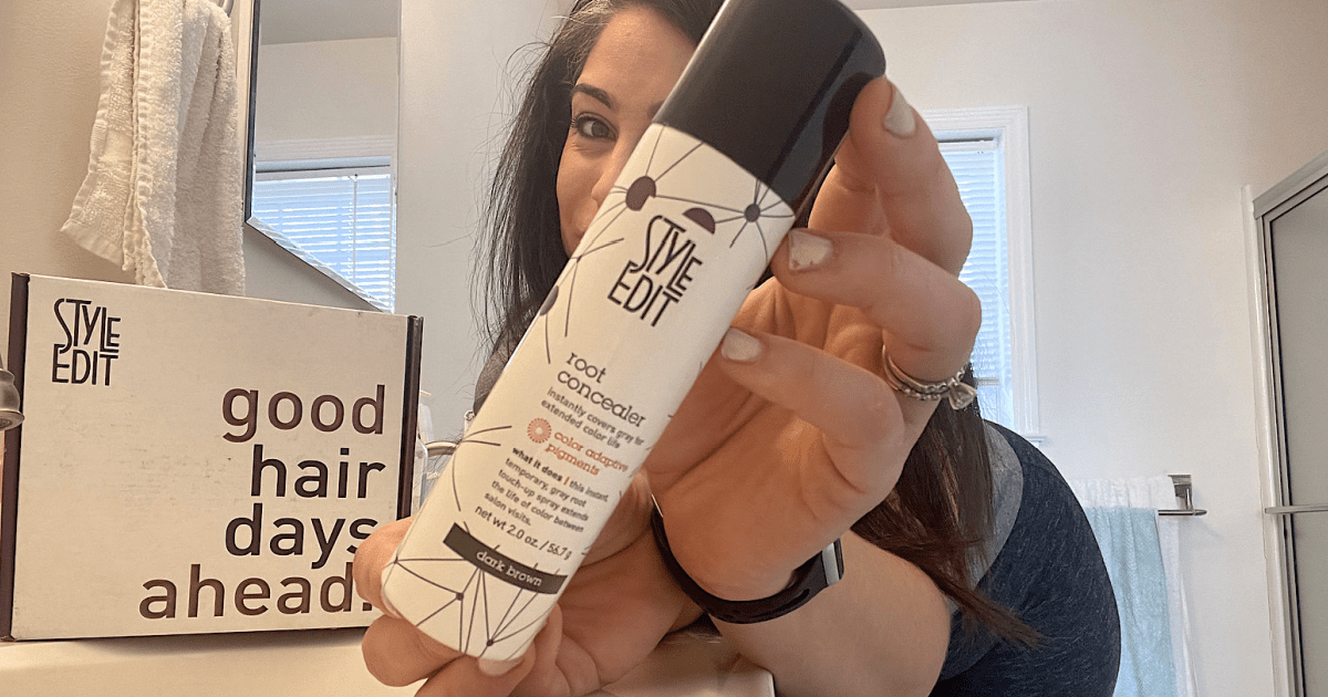 woman holding a bottle of Style Edit Root Concealer 