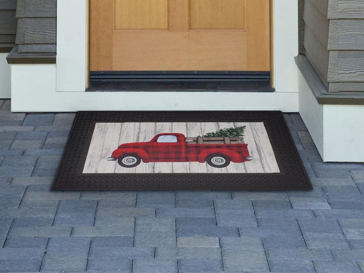 truck and christmas tree doormat on front porch
