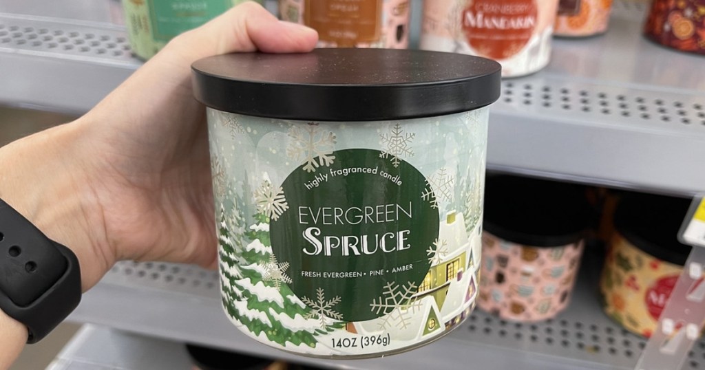 holding an Evergreen Spruce candle