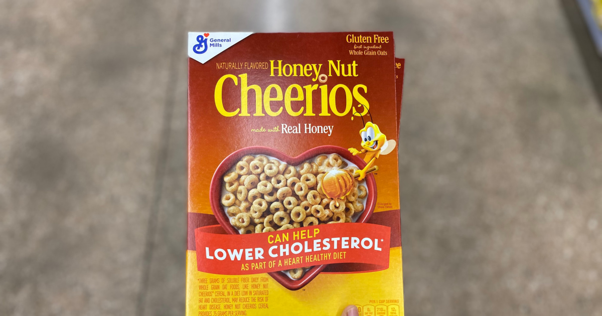 box of cheerios being held above a stone background