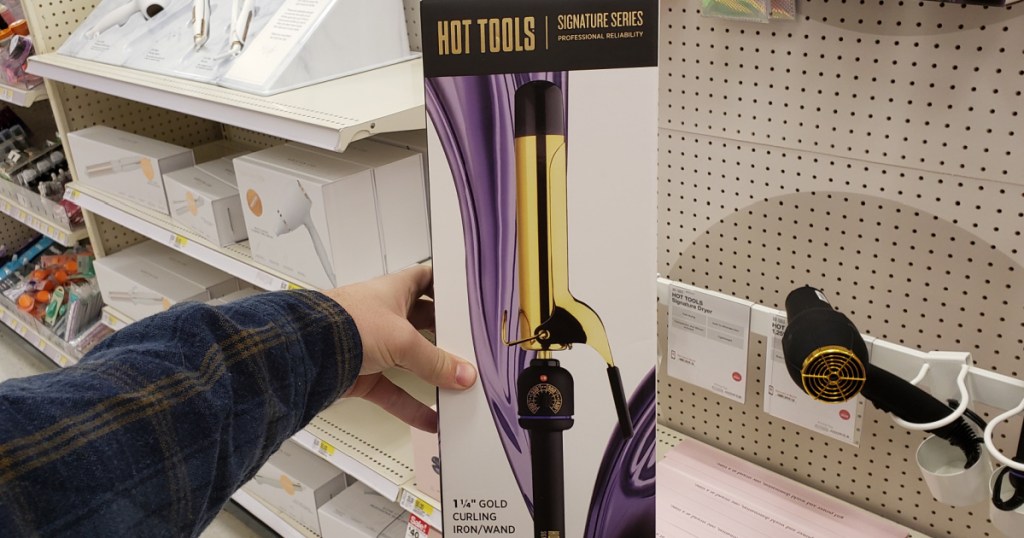 hand holding package with curling iron in store