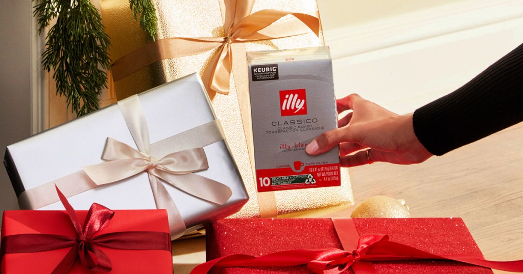 illy coffee in hand with gifts