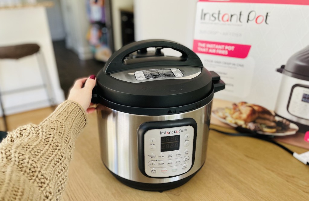 hand holding side of instant pot air fryer