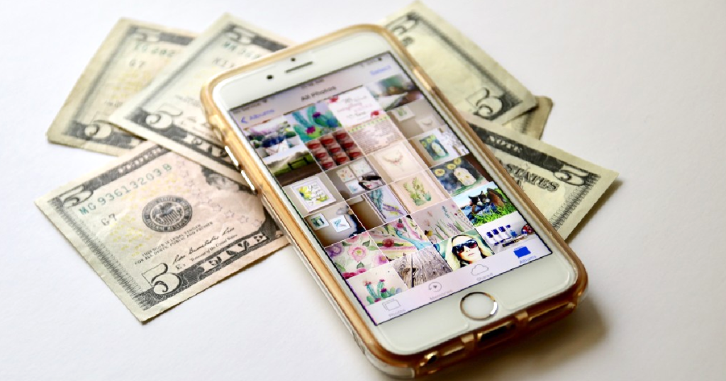 iPhone on counter with dollar bills 