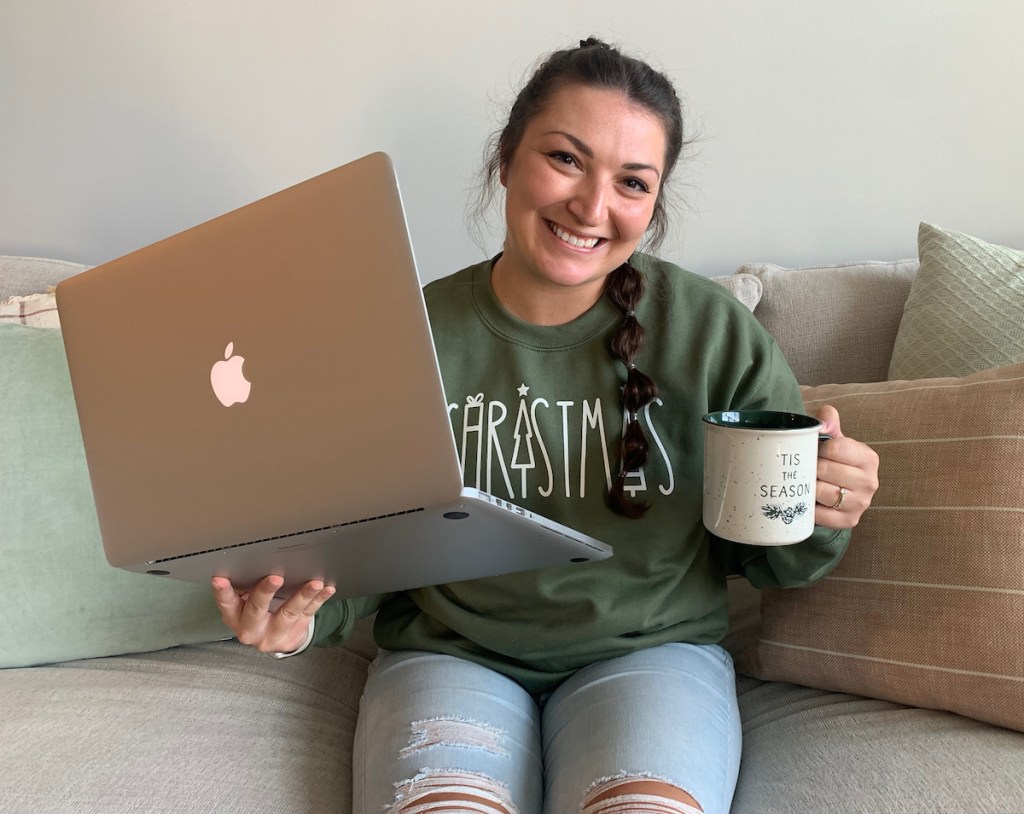 woman sitting on couch with laptop and coffee mug