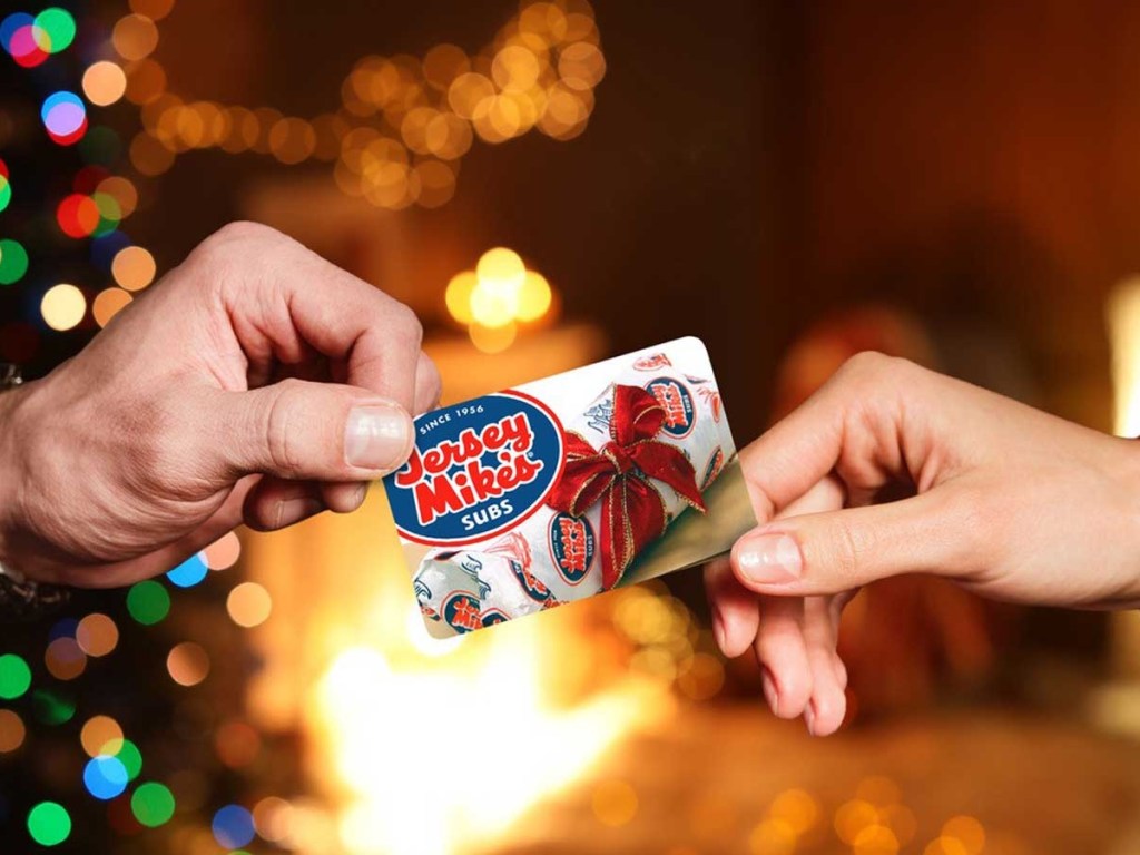 2 hands holding a Jersey Mike's gift card
