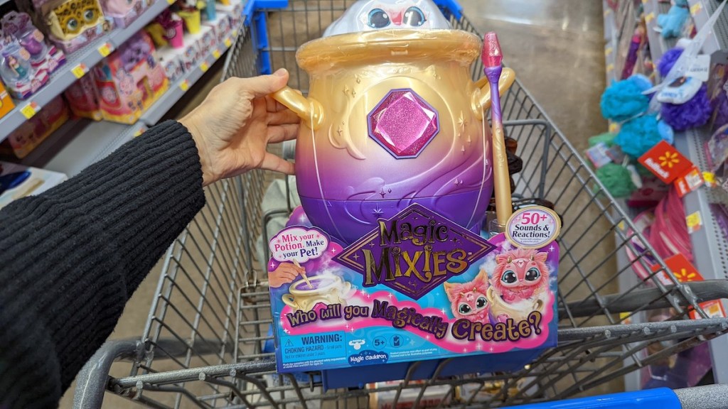 hand holding magic mixies toy in box over walmart cart