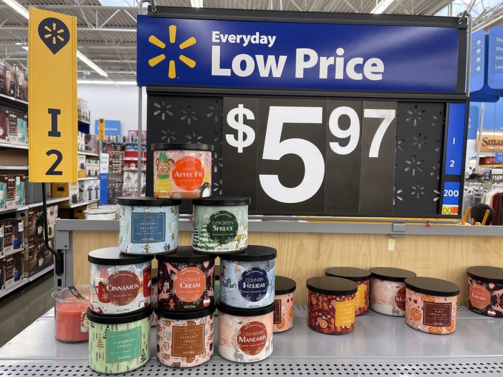 candles stacked up in front of Walmart price sign