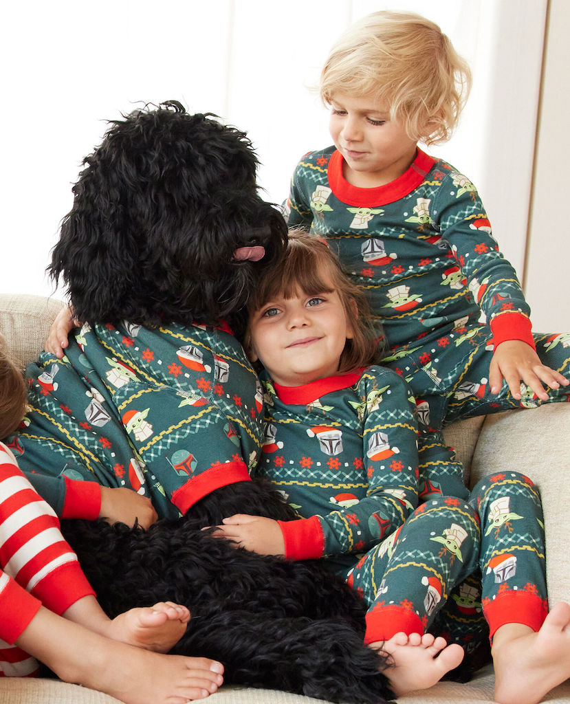 brother, sister and dog wearing matching family pajamas 
