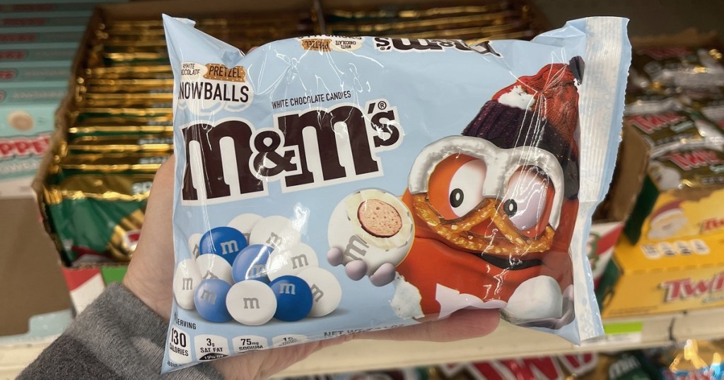 holding a bag of Snowball M&M's