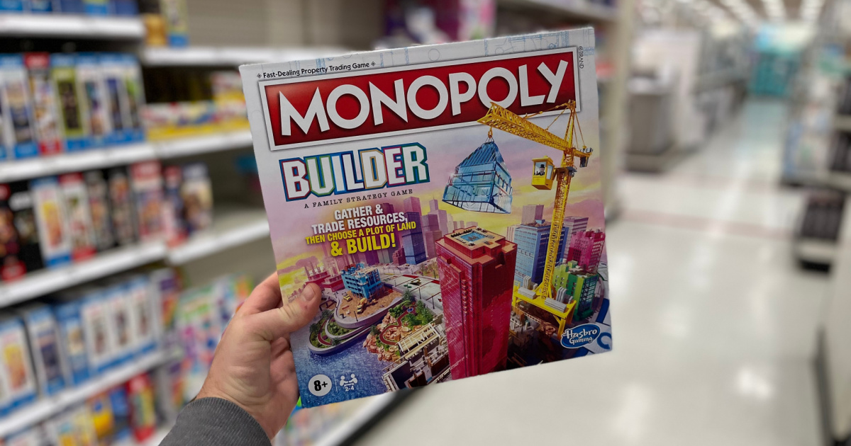 target board games sale - hand holding up monopoly builder game