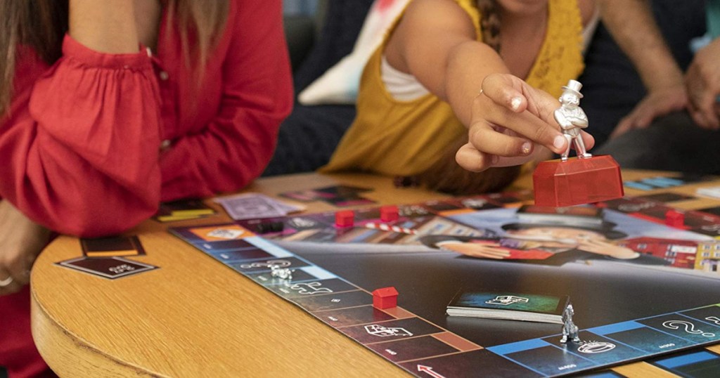 people at table with board game in front of them