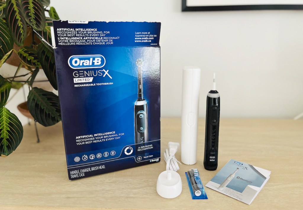 oral b genius x limited toothbrush with box on wood table