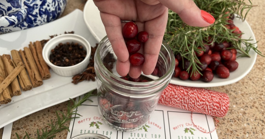 pouring cranberries into a jar