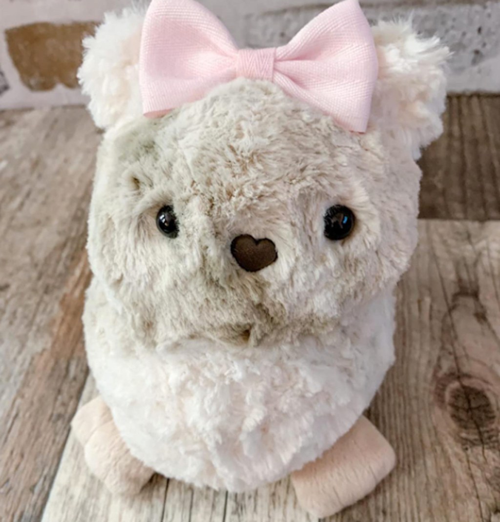 furry stuffed animal with pink bow on head - hot toys for christmas