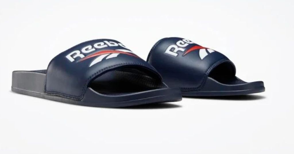 navy red and white Reebok slides