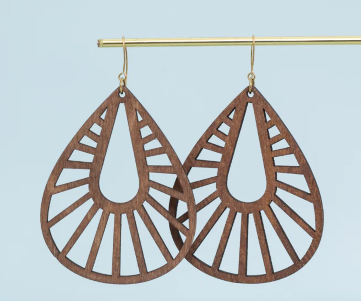 wooden earrings hanging on gold bar