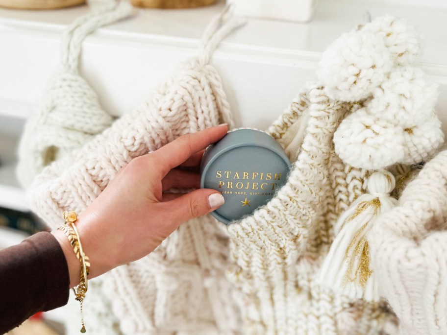 hand placing jewelry box in stocking