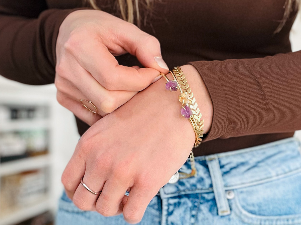 woman showing cuff bracelets on wrist