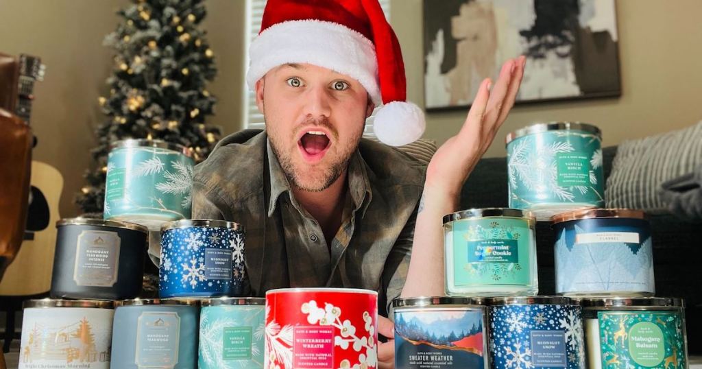 man with santa hat and tons of bath and body works candles