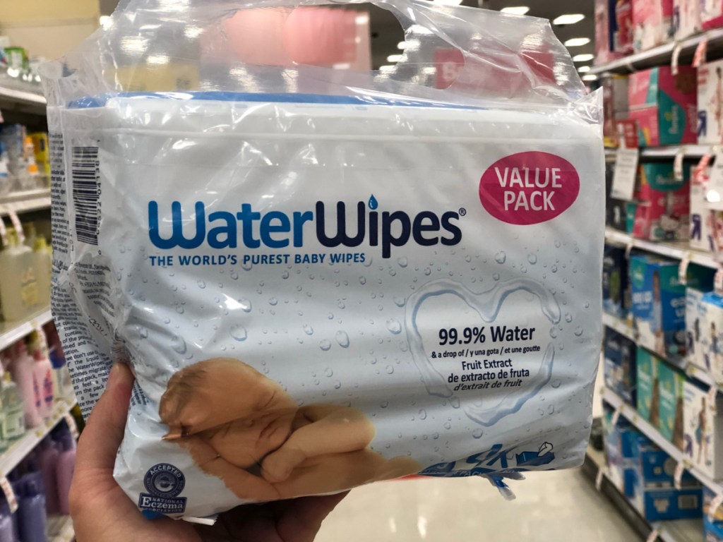 hand holding package of baby wipes in store