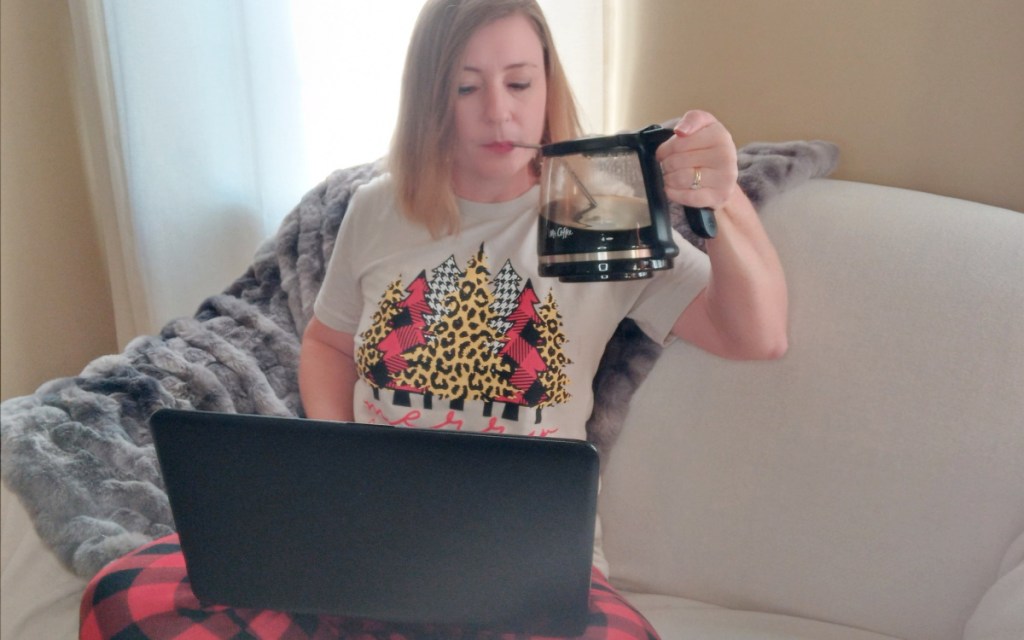 woman drinking from coffee pot