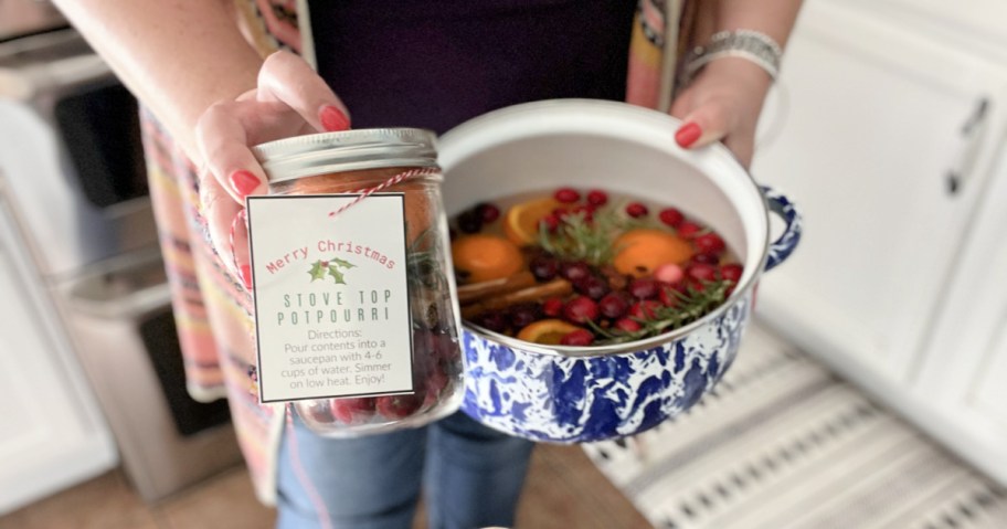 woman holding stove top potpourri jar and pot