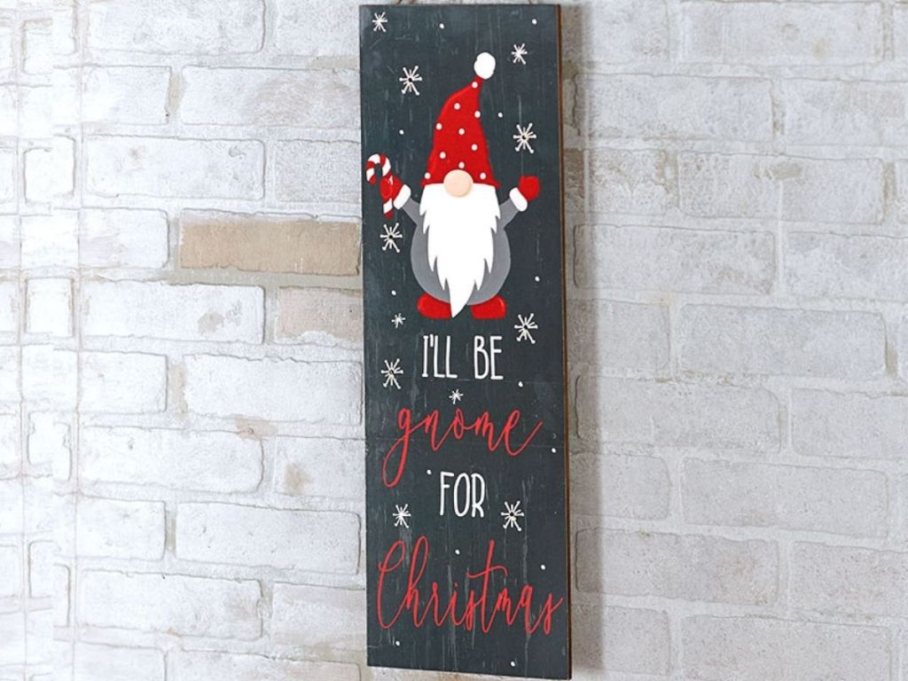 Gnome Christmas sign on white brick wall