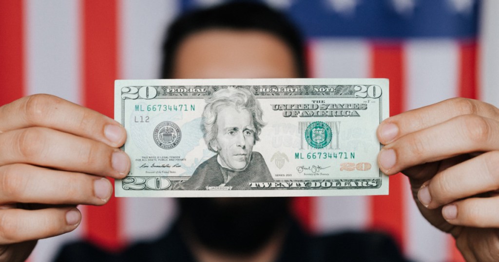 man holding a 20 dollar bill