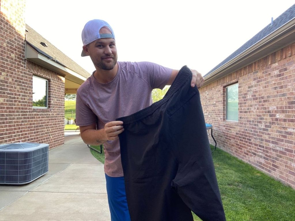 man holding a pair of shorts