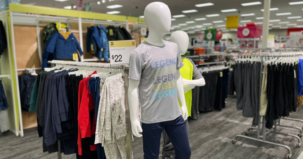 mannequin in activewear in front of kids' clothing section 