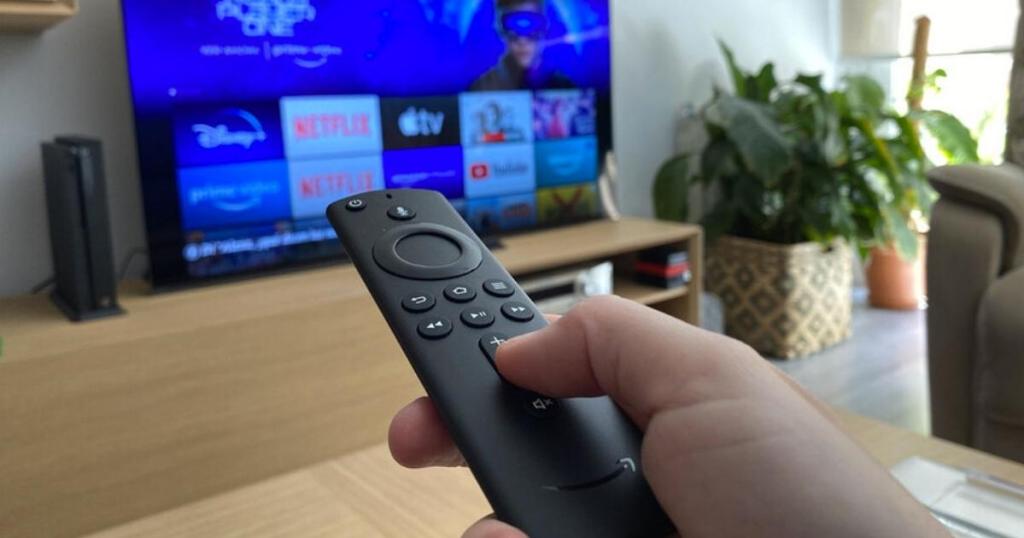 amazon fire tv remote with home screen on tv