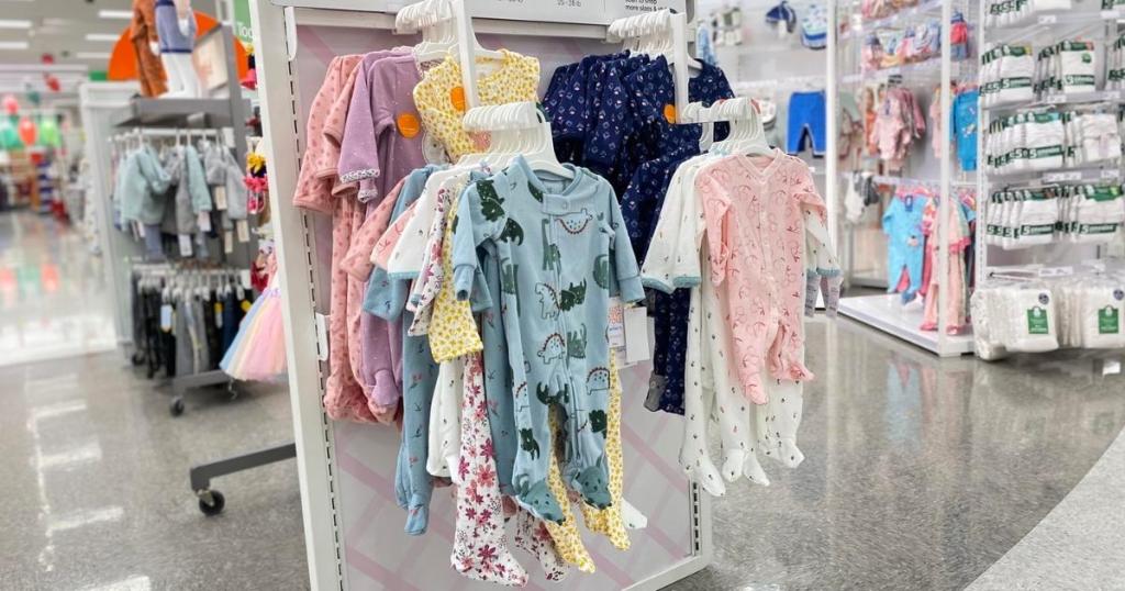 carter's baby footed pajamas hanging in store